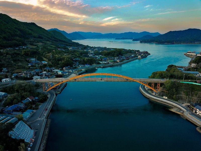 mountain range, sea, yellow bridge, tranquility, tranquil scene, city, waterfront, shiminami kaido, bay, cloud - sky, ocean, ocean town, sunset, built structure
