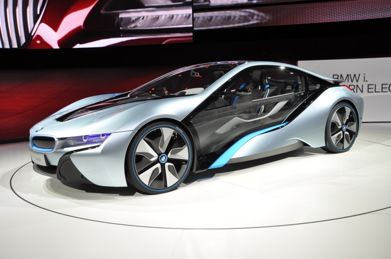retail, modern, motor vehicle, luxury, indoors, convertible, mode of transportation, racecar, red, land vehicle, showroom, shiny, wealth, no people, sports car