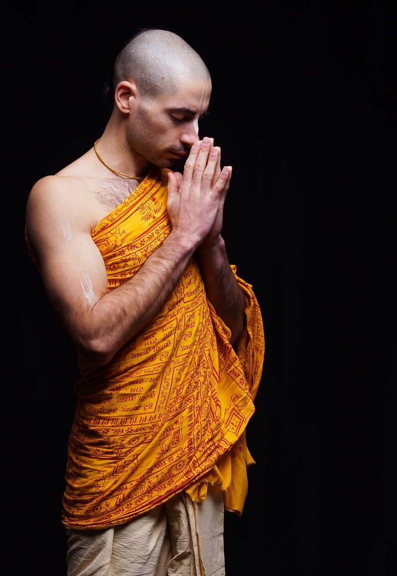 casual clothing, spiritual, mantra, men, hindu, studio shot, shaved head, st, looking down, yoga, black background, india, standing, waist up, krishna