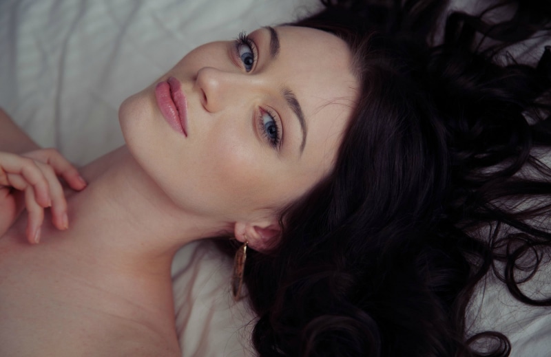 wavy hair, lifestyles, headshot, hairstyle, close-up, portrait, looking at camera, real people, looking at viewer, lying on back, Zsanett Tormay, brunette