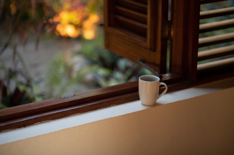 food and drink, saucer, focus on foreground, wood - material, french door, coffee, pottery, picture window, brown, white, tea cup, hardwood, coffee - drink