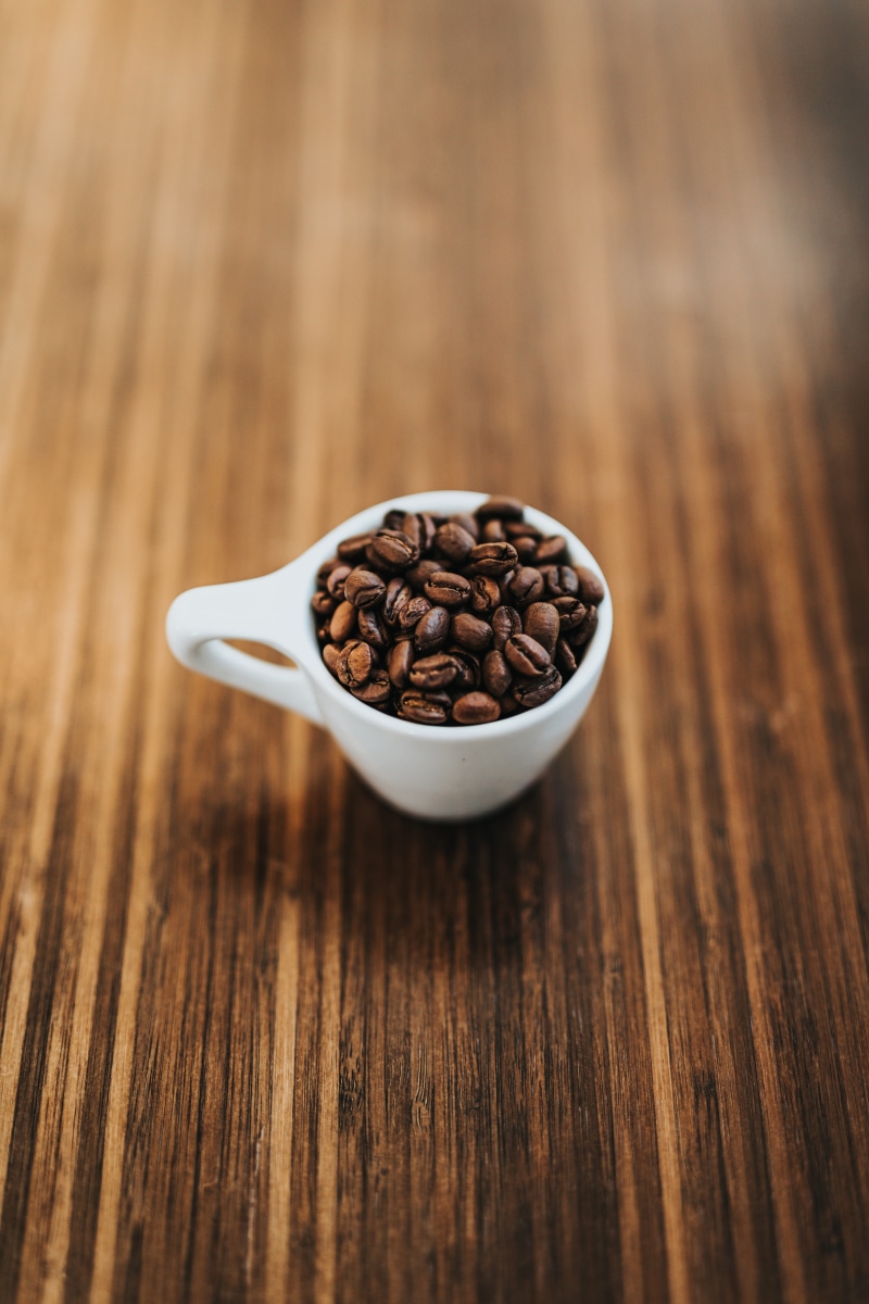wooden table, coffee bean, ceramic, 5K, crockery, coffee roaster, coffee shop, still life, selective focus, roast, coffee, coffee mug, mocha, roasted coffee bean