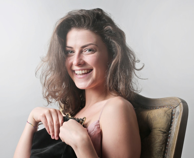 Laughing, Smiling, holding, women, hair, female, sit, caucasian, headshot, front view, Happy, beauty, One Woman Only, white, Sitting, beautiful woman, adult