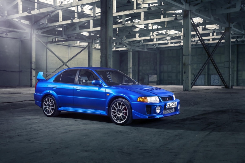 mode of transportation, communication, Mitsubishi, architecture, indoors, illuminated, blue, garage, evolution, transportation, land vehicle, sports car