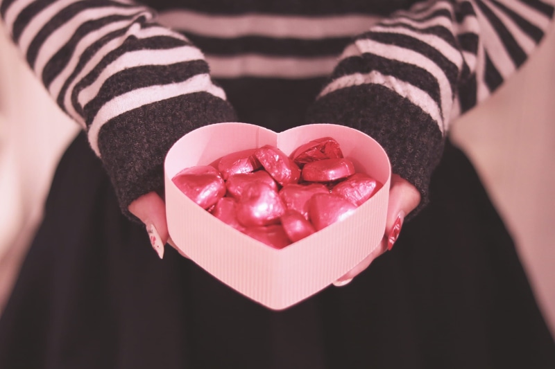 candy heart, one person, midsection, box - container, giving, human body part, person, candy bars, box, candy, hands cupped, close-up, white, women, red