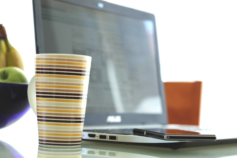 indoors, monitor, connection, pc, office, computer, communication, business, laptop, food and drink, cup, notebook, cell phone, write, refreshment, household equipment