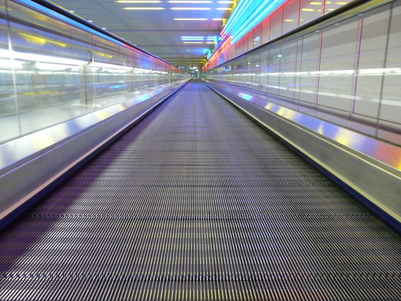 indoors, futuristic, movement, transport, escalator, rolling pavement, station, moving walkway, transportation, built structure, long, motion, direction