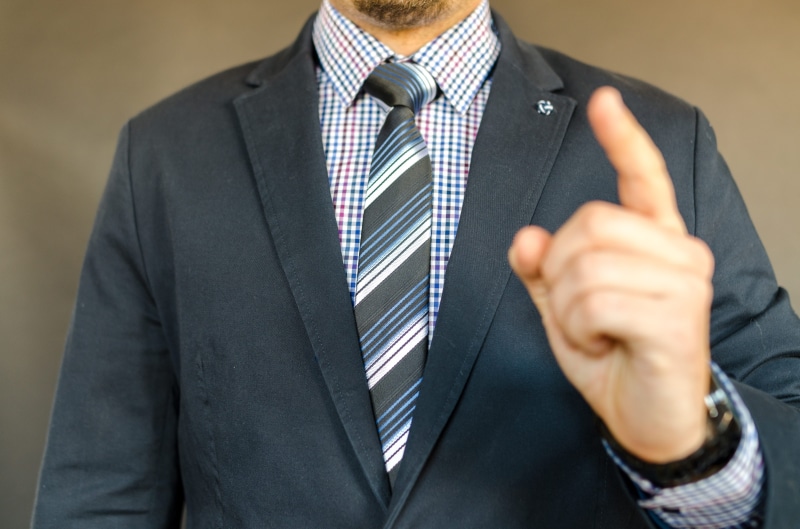 one person, formal businesswear, necktie, man, indoors, menswear, formal, professional occupation, front view, elegant, guy, corporate business, person