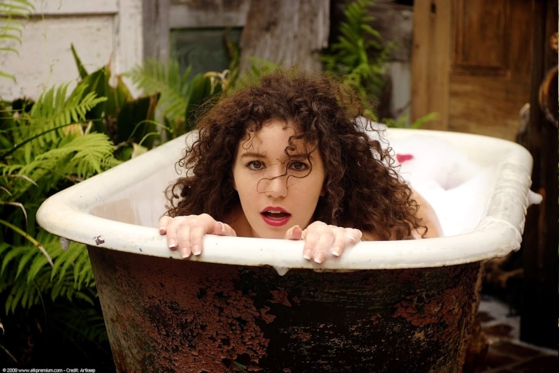females, hair, real people, one person, leisure activity, hairstyle, domestic bathroom, mouth open, bathroom, front view, In Bathtub, portrait, women, curly hair