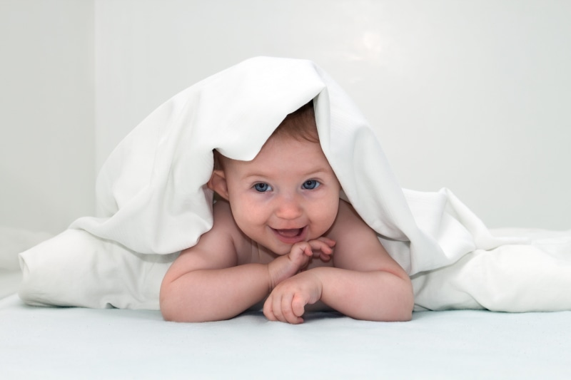 looking At Camera, textile, cheerful, people, blanket, beautiful, child, joy, indoors, babies Only, crawling, toddler, small, males, studio Shot, human Eye