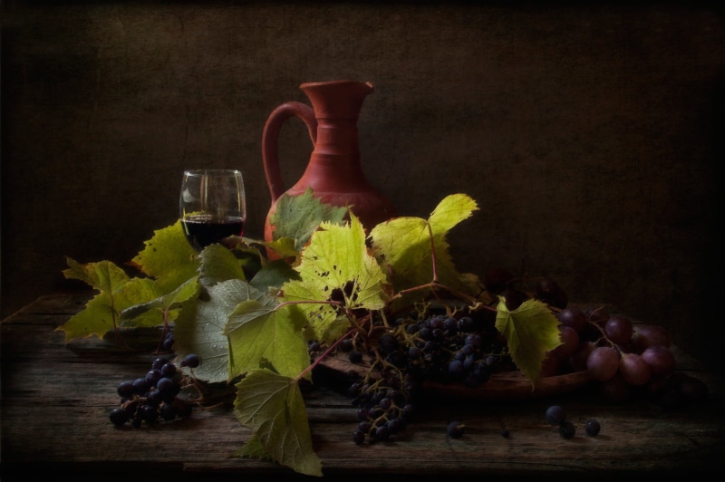 red wine, table, freshness, indoors, flowering plant, wine, plant, vase, food and drink, flower, glass, black background, fruit, grapes, studio shot, food