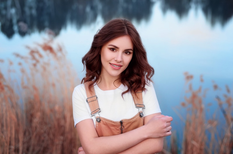 Vladislav Opletaev, women outdoors, women, bokeh, face, long hair, 1080P, white t-shirt, portrait, overalls, wavy hair, brown eyes, brunette, smiling