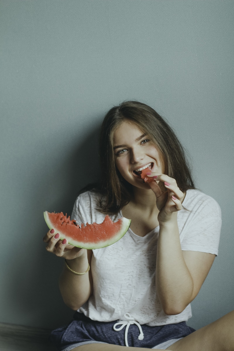 food, food and drink, front view, casual clothing, looking at camera, fruit, white, fashionable, long hair, lifestyles, one person, young, healthy eating