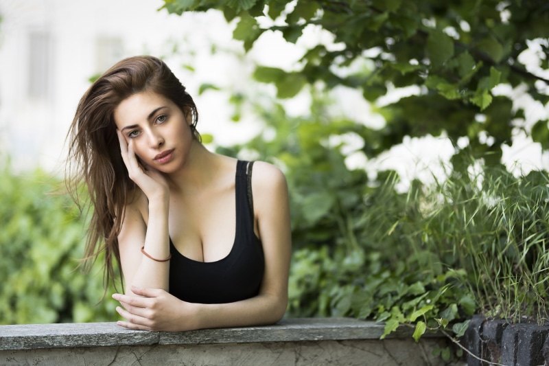 looking at viewer, leaves, 2K, Luigi Malanetto, wavy hair, outdoors, cleavage, women, hand on face, tank top, brunette, Serena Nemera