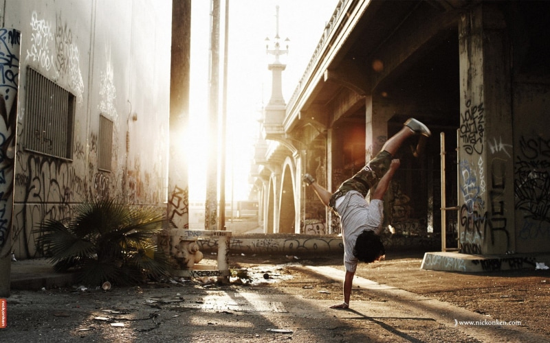 outdoors, sunlight, nature, casual clothing, handstand, day, urban, healthy lifestyle, rear view, full length, exercising, city, lifestyles, building exterior