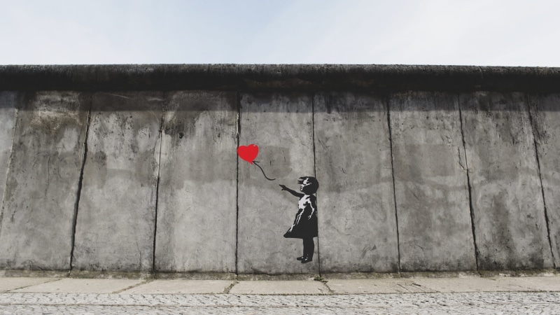 casual clothing, playing, architecture, red, built structure, balloon, heart, leisure activity, creative, building exterior, wall, outdoors, stone wall