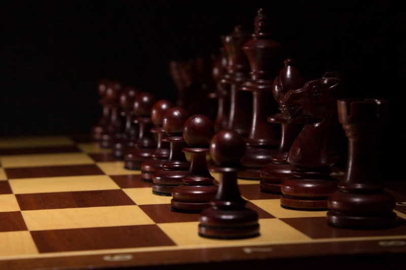 arts culture and entertainment, chess board, relaxation, knight - chess piece, competition, challenge, studio shot, black, leisure activity, chess piece