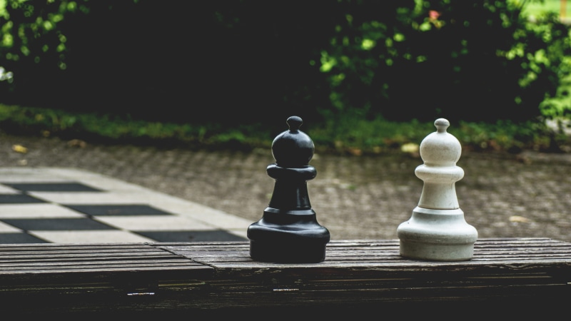 outdoors, focus, pawn - chess piece, leisure games, king - chess piece, chess board, focus on foreground, close-up, figure, black-and-white, strategy, leisure activity