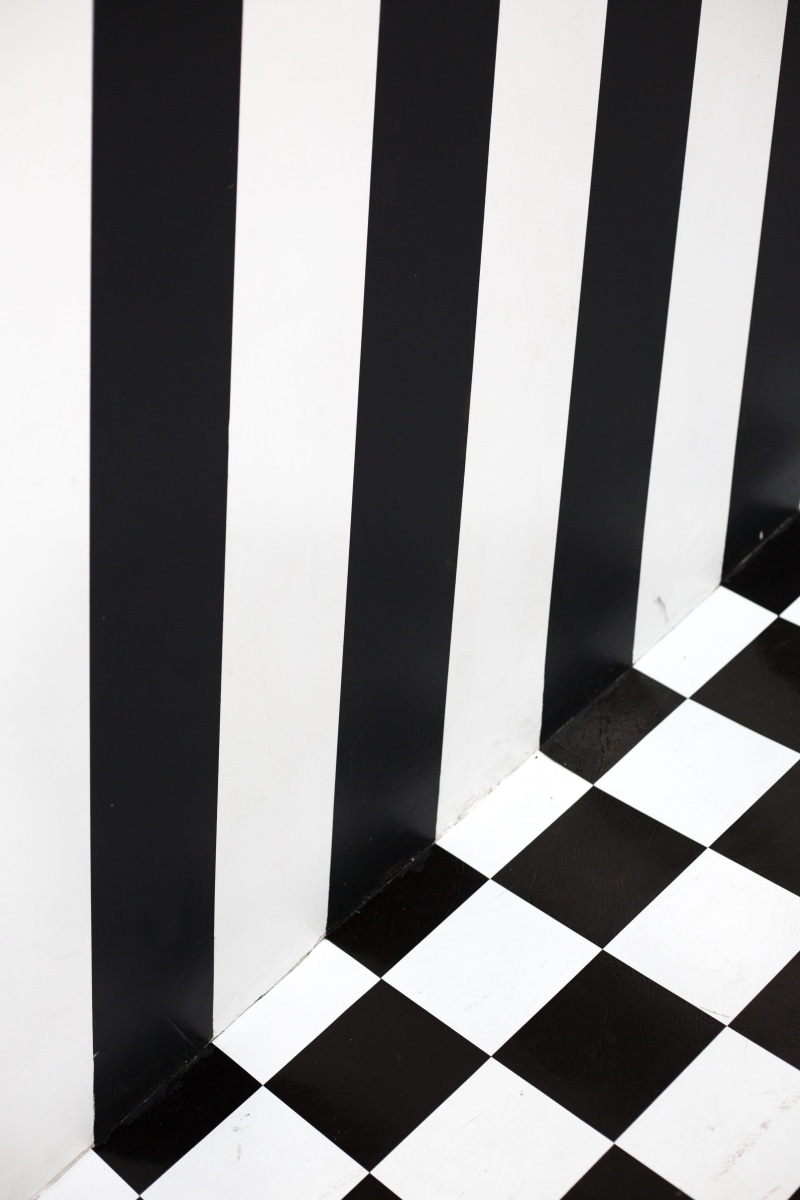 high angle view, no people, tiled floor, black and white, checked pattern, flooring, architecture, stripes, shape, repetition, full frame, wall - building feature