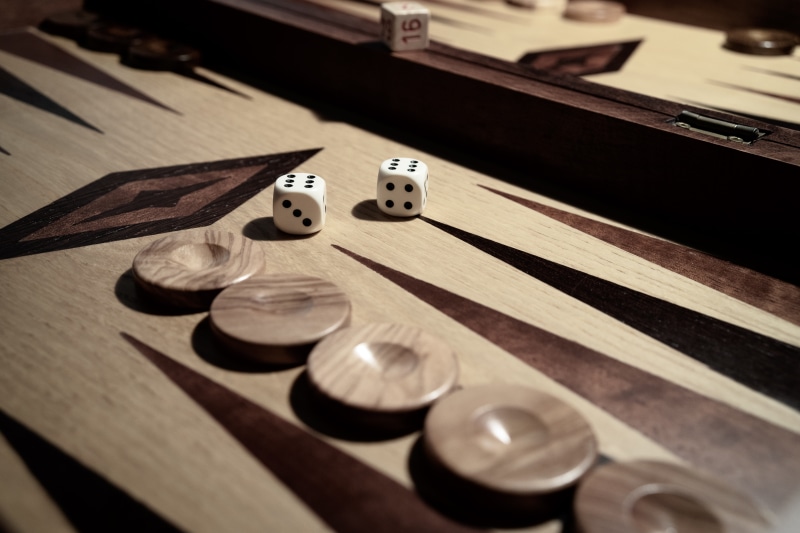 wood, cube, pay, table, chance, luck, play, group of objects, entertainment, games suitcase, coin, board game, indoors, selective focus, competition, no people