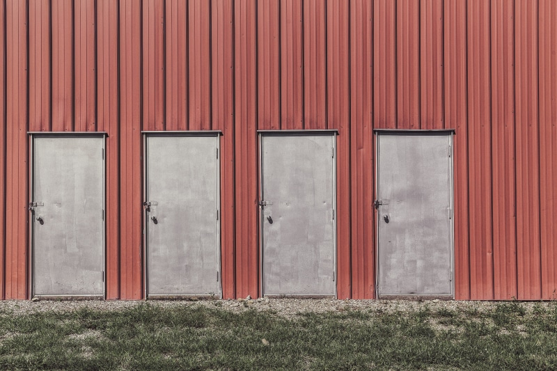 green, building exterior, red, doors, corrugated, wood - material, safety, closed, gray, pattern, outdoors, urban, barn, architecture, warehouse, grass