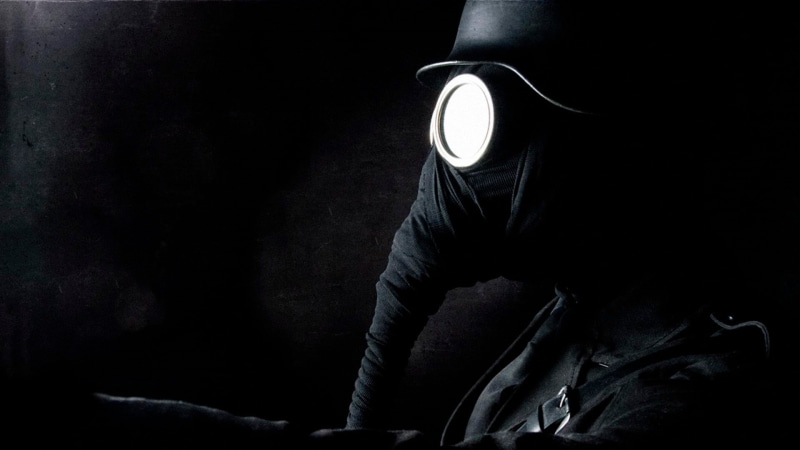 holding, illuminated, indoors, obscured face, one person, Stahlhelm, black background, security, lighting equipment, hood - clothing, World War I, night