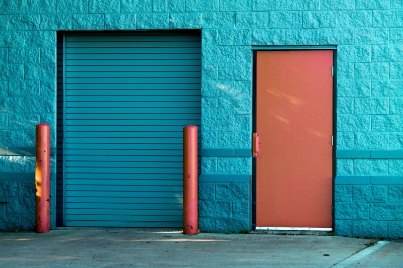 gate, architecture, street, pavement, metal, red, building, wall, building exterior, outdoors, door, wall - building feature, near, garage, panel, closed