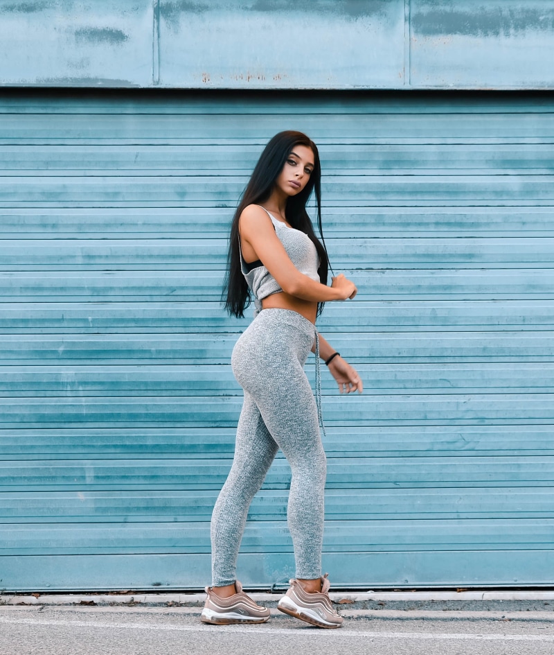 leisure activity, girl, long sleeve, female, real people, beauty, wall - building feature, pants, woman, apparel, shorts, young adult, one person, sleeve