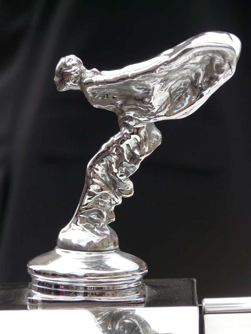 table, black background, close-up, shape, day, single object, distinguishing, glass - material, gloss, silver colored, statue, shiny, still life, sculpture