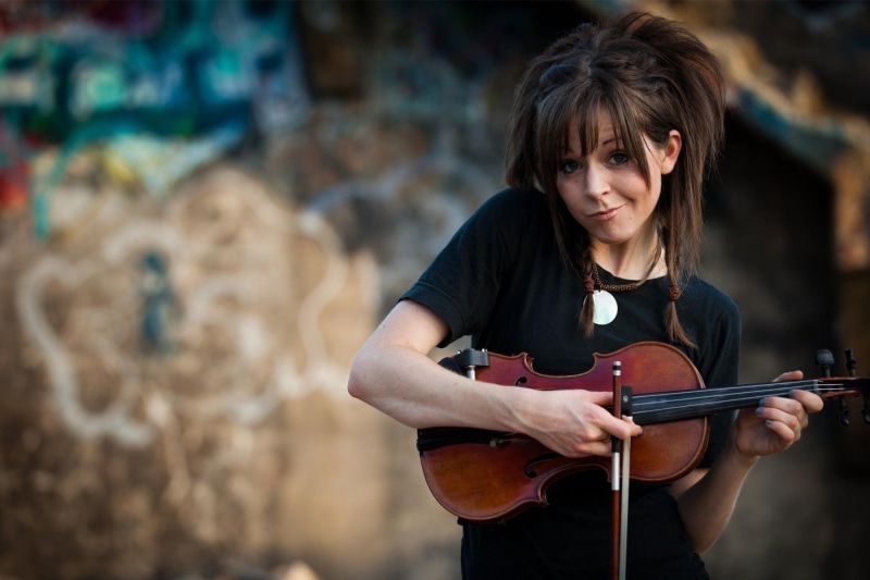 focus on foreground, looking at camera, portrait, artist, women, arts culture and entertainment, adult, violin, string instrument, happiness, skill, music