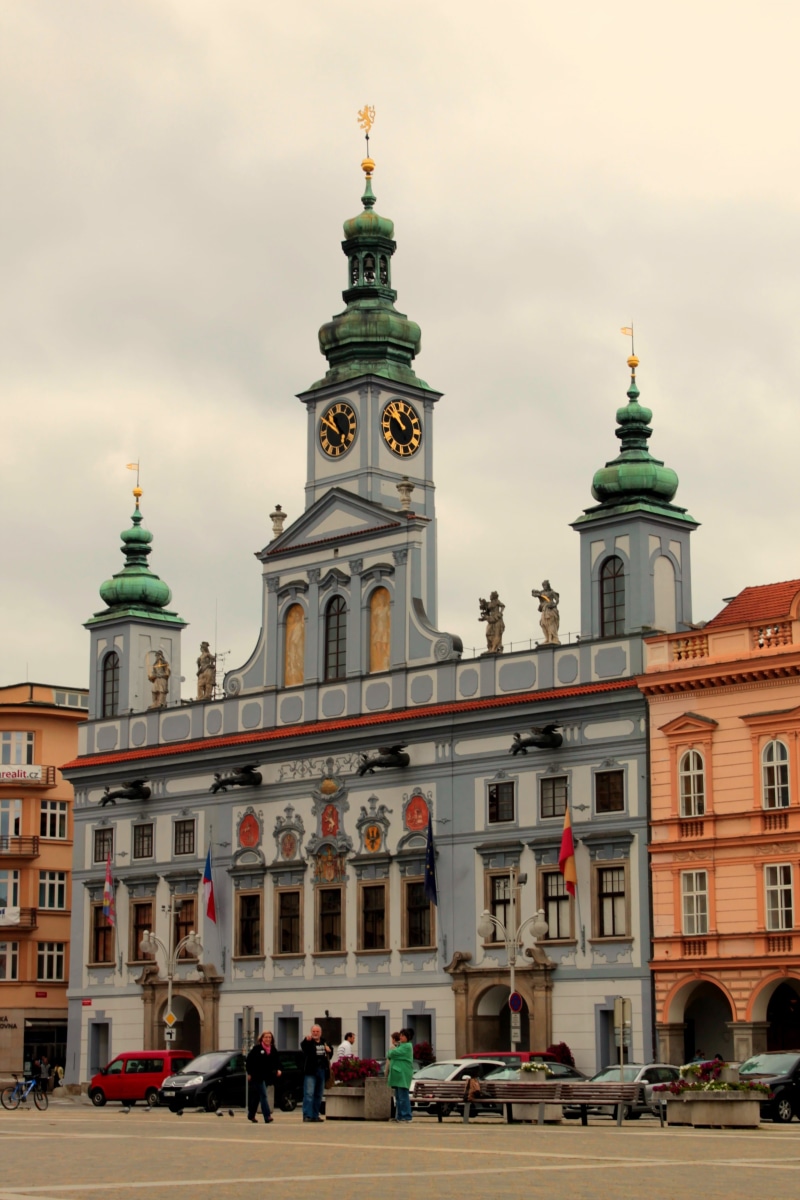 building exterior, religion, car, transportation, czech budejovice, outdoors, square, old building, mode of transportation, city ​​center, travel, spire