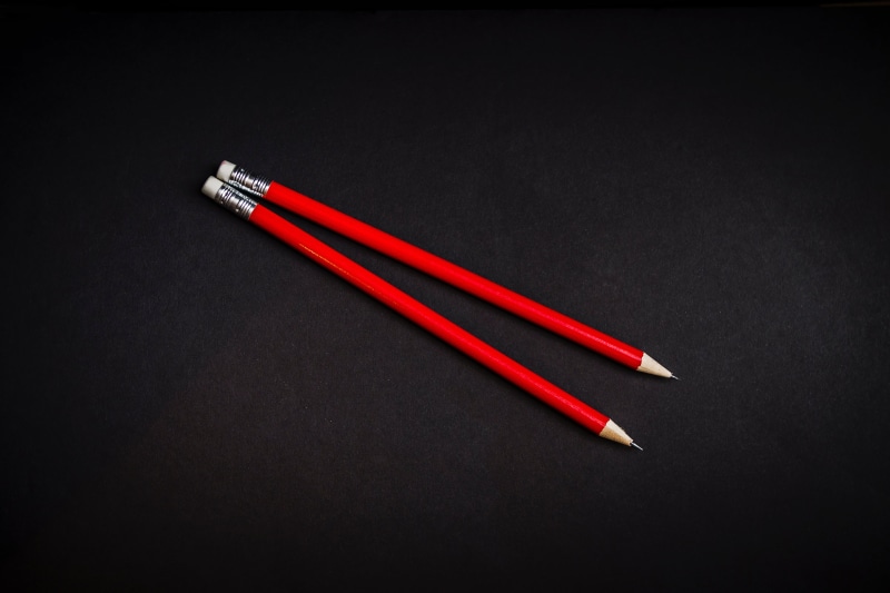 black color, cut out, studio shot, writing instrument, indoors, drawing, wood - material, colored pencil, write, high angle view, black background, still life
