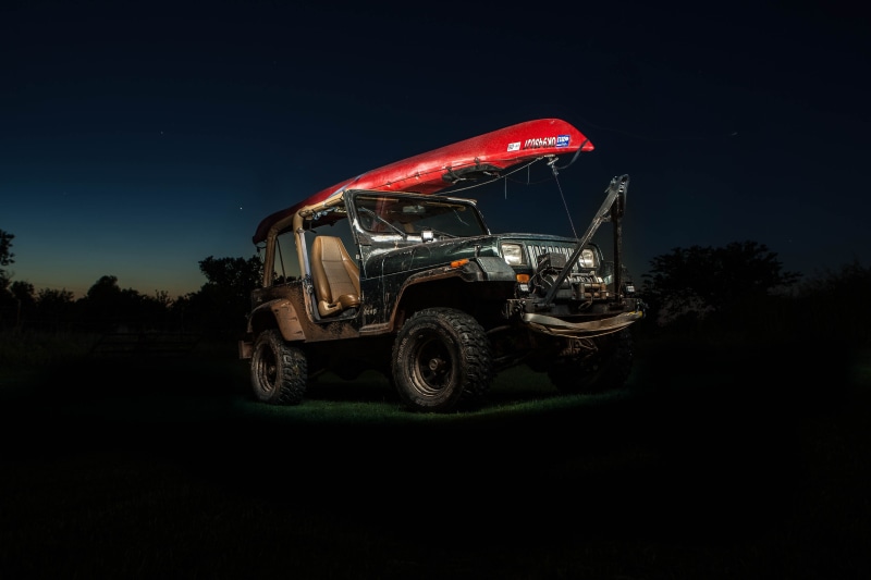 motor vehicle, no people, 4x4, black background, red, trucking, near, dark, black, sky, jeep, adventure, nature, star, wheel, trees, mode of transportation
