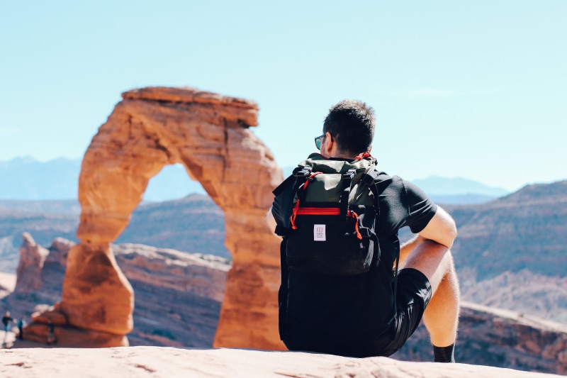 leisure activity, arch, backpack, hill, rock formation, landscape, park, 5K, climbing, scenics - nature, facing, hiking, looking at view, scuba diving