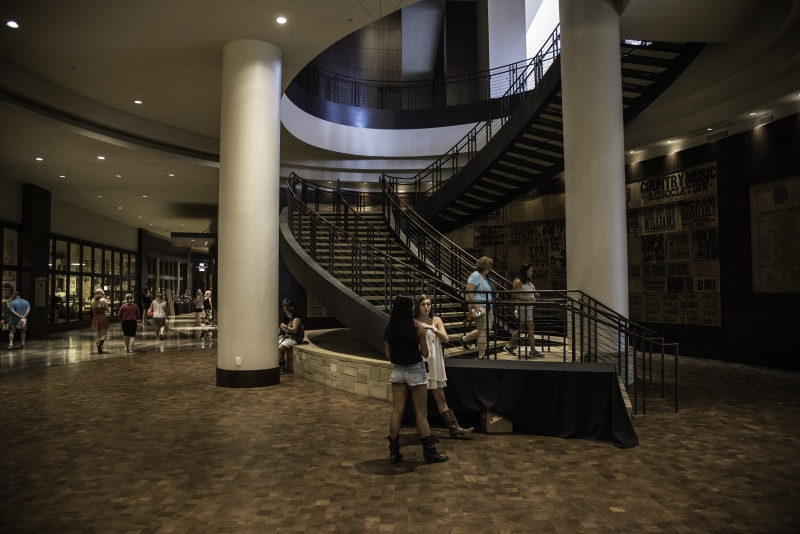 incidental people, railing, night, lifestyles, people, adults only, Spiral staircase, real people, full length, city, urban Scene, subway Station, only women