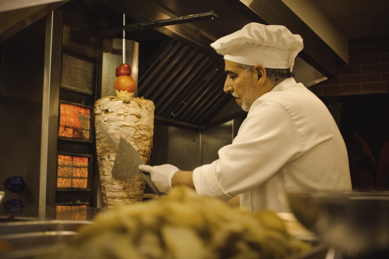 clothing, cook, food and drink establishment, commercial kitchen, kebab, baker - occupation, real people, standing, preparing food, store, indoors, chef