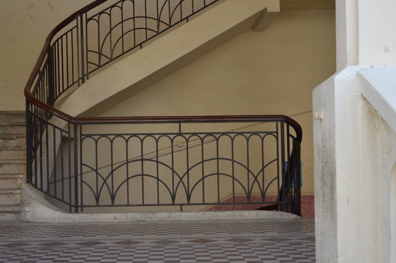 up and down, staircase, building, wall - building feature, 2K, stairs, wrought iron, metal, steps and staircases, day, railing, outdoors, no people, empty