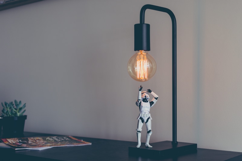costumer, light bulb, innovation, single object, spark, electric lamp, stormtrooper, standing, no people, electricity, technology, lamp, figure, table