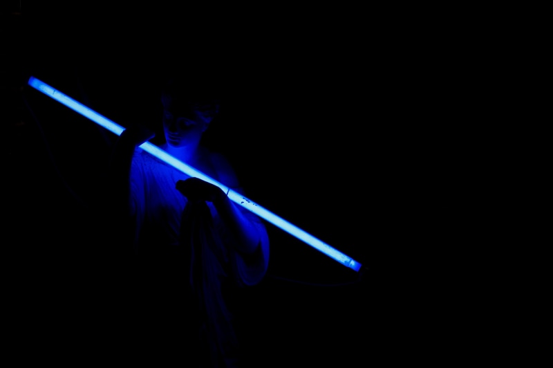 led, indoors, blade, sundial, person, side view, blue, 4K, studio shot, close-up, statue, sword, aggression, one person, weapon, neon, illuminated, hula