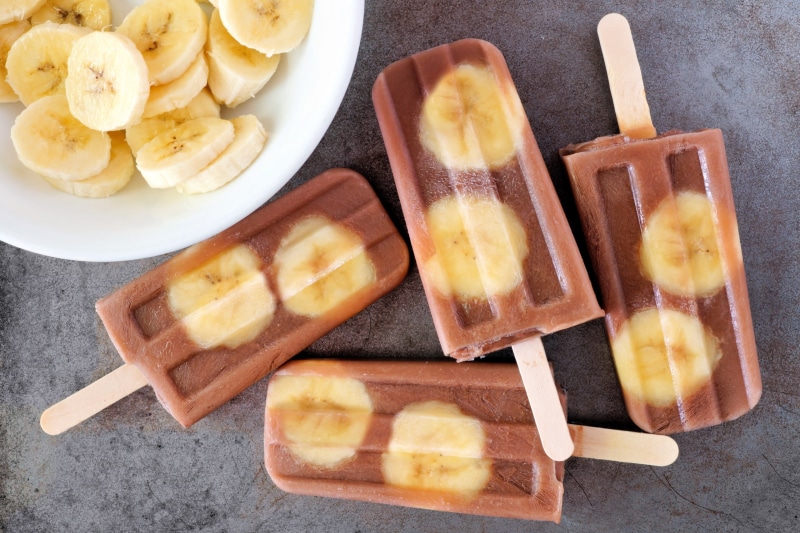 2K, healthy eating, bowl, food, food and drink, bananas, popsicle, sweet food, indoors, table, directly above, cutting board, dairy product, frozen, high angle view