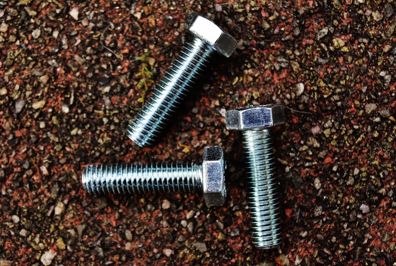 focus on foreground, bolt, no people, directly above, two objects, nut - fastener, screw, high angle view, close-up, indoors, equipment, 5K, construction material