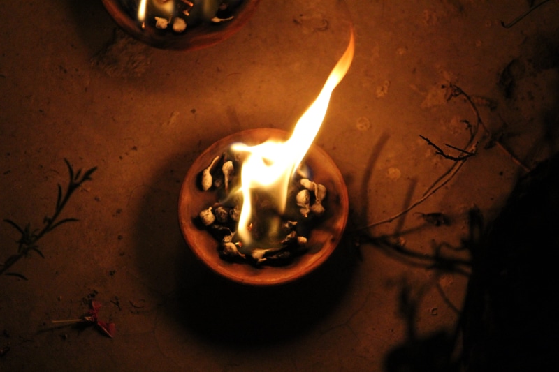 lighting equipment, high angle view, nature, hindu, heat - temperature, lamp, close-up, electric lamp, prayer, diwali, illuminated, night, woman, water