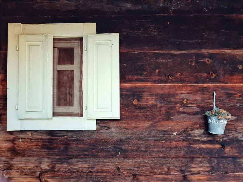 window, porthole, built structure, flowers, flare, light, wooden, hardwood, building exterior, brown, wood, white, window frame, house, bucket, cabinet
