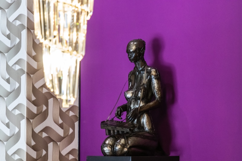 creativity, person, art, human representation, leisure activities, statue, buddha, purple, male likeness, belief, sphere, sculpture, clothing, crystal