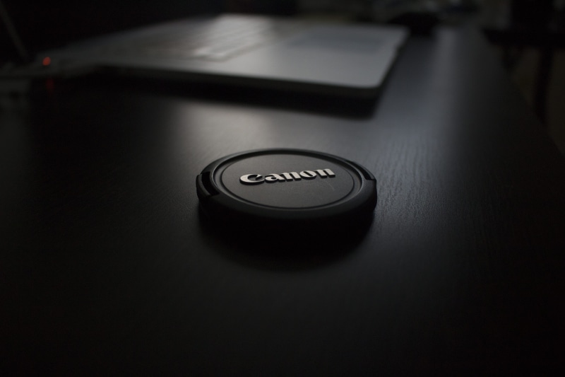camera - photographic equipment, studio shot, protective covering, indoors, black, zoom, single object, camera lens, computer language, push button, photography themes