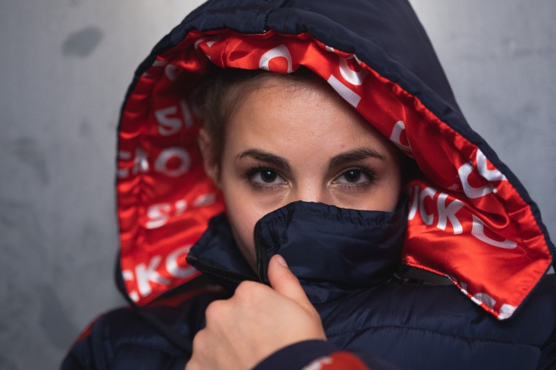 indoors, model, red, protection, mid adult, young adult, pretty, human face, human body part, photoshoot, looking at camera, covered, one person, hand