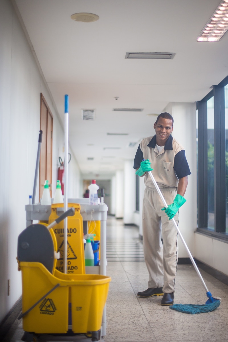 mop, looking at camera, cleaner, hygiene, working, real people, indoors, occupation, care, inside, front view, broom, uniform, adult, inside the house