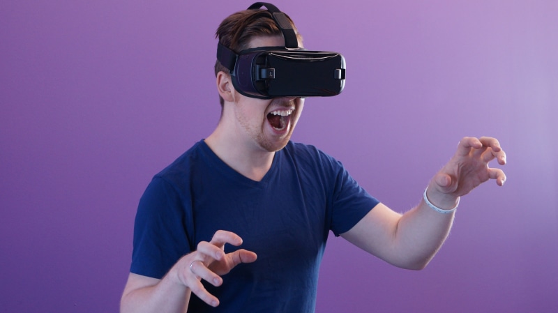 colored background, human body part, mouth open, wireless technology, man, human arm, mouth, virtual reality simulator, adult, vr, glasses, one person