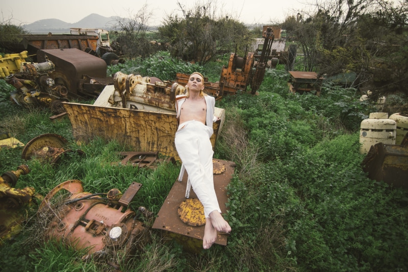 model, wear, field, outdoors, building exterior, white, green color, wearing, stool, plants, day, rustic, lifestyle, nature, portrait, person, rust, vehicle