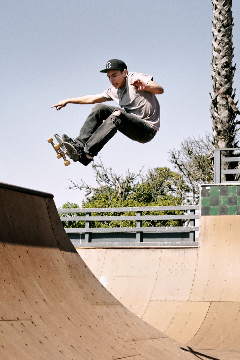 outdoors, balance, adolescence, skateboarder, one person, hobby, mid-air, day, park, motion, nature, skater, man, sky, jump, architecture, human arm, stunt